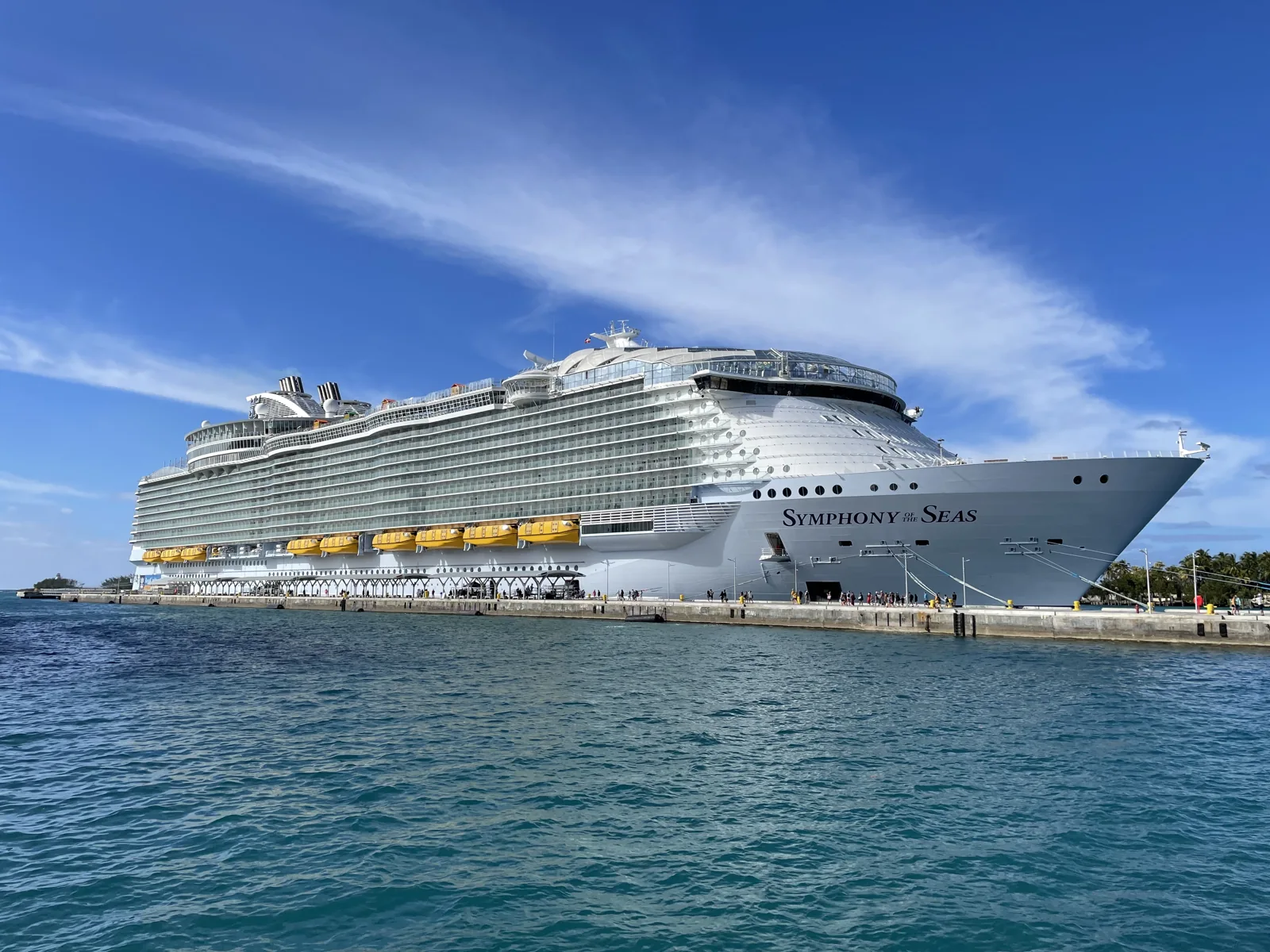 Navio Symphony of the Seas, da Royal Caribbean, atracado em Nassau, nas Bahamas, sob céu azul.