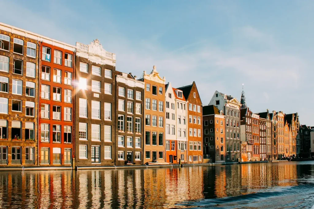 Prédios coloridos à beira de um canal em Amsterdam