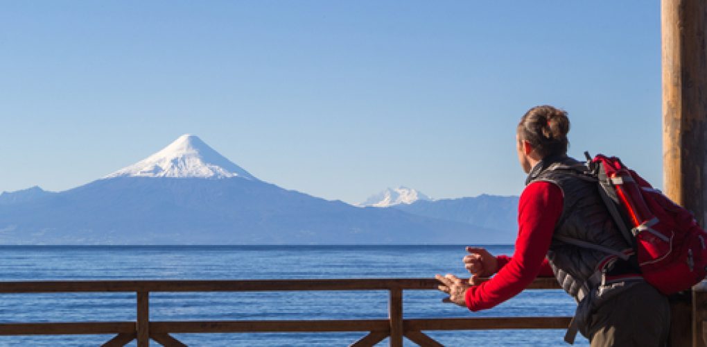 The,Tourist,Looks,At,The,Osorno,Volcano.pier,At,Llanquihue,Lake,